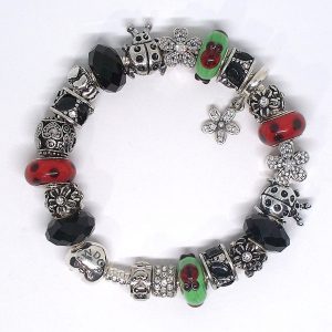 Ladybug charm bracelet with red, green, black, silver, heart clip, Murano glass, faceted glass, floral details, and European-style charms on an authentic Pandora bracelet