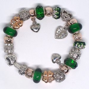 Green charm bracelet with green, gold, rose gold, silver, heart clip, Murano glass, faceted glass, lucky details, and European-style charms on an authentic Pandora bracelet
