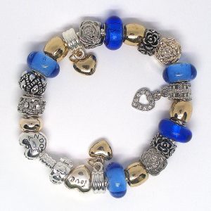 A blue & gold 925 charm bracelet with royal blue, gold, silver, heart clip, love details, Murano glass beads, and European-style charms on an authentic Pandora bracelet