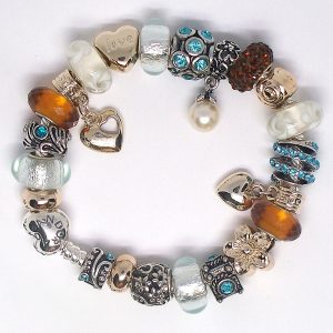 Boho charm bracelets style with turquoise blue, amber, ivory, gold, silver, sea glass details, Murano glass, faceted beads, pavé crystal, and European-style charms on an authentic Pandora bracelet