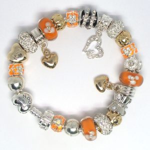 Orange charm bracelet with orange, gold, silver, crystal, heart clip, Murano glass, pavé crystal, and European-style charms on an authentic Pandora bracelet