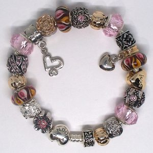 Authentic Pandora fall charm bracelet with retro European-style charms Warm toned charm bracelet with pink amber gold and floral accents