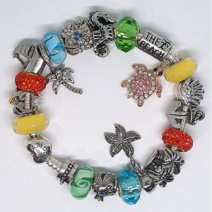 Sterling silver beach charm bracelet with pink, blue, green, orange, silver, gold, Murano glass, faceted beads, palm tree dangle, shell charm, and European charms on an authentic Pandora bracelet