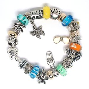 Tropical beach charm bracelet with blue, green, orange, yellow, silver, dolphin, starfish, octopus, fish, flip flop, Murano glass, and European-style charms on an authentic Pandora bracelet