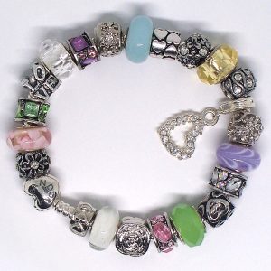 Pink pastel charm bracelet with pink, lavender, white, silver, Murano glass, faceted glass, heart, and European-style charms on an authentic Pandora bracelet