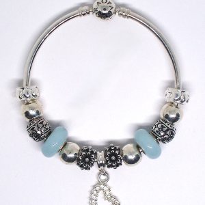 Blue bangle bracelet with pastel blue, silver, floral, heart, Murano glass, sparkle, and European-style charms on an authentic Pandora bangle