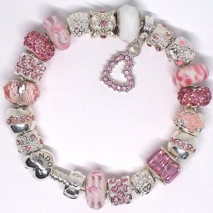 Coquette charm bracelet with pink, white, silver, heart, strawberry-inspired, Murano glass, pavé crystal, and European-style charms on an authentic Pandora bracelet