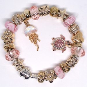 Pink beach charm bracelet with pink, gold, white, silver, turtle, Murano glass, pavé crystal, and European-style charms on an authentic Pandora bracelet