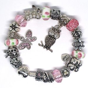 Pink and green nature inspired charm bracelet with owl and butterfly charms